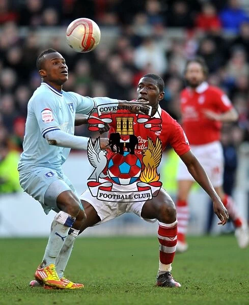 Intense Rivalry: Moussi vs. Nimely's Battle for Ball Supremacy in Coventry City's Championship Showdown at Nottingham Forest (18-02-2012)