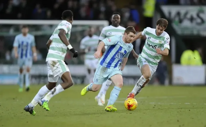 Framed Print : John Fleck Evades Pressure from Nathan Smith and Sam Foley in Coventry City's Sky Bet League One Clash at Huish Park Framed Print : John Fleck Evades Pressure from Nathan Smith and Sam Foley in Coventry City's Sky Bet League One Clash at Huish Park