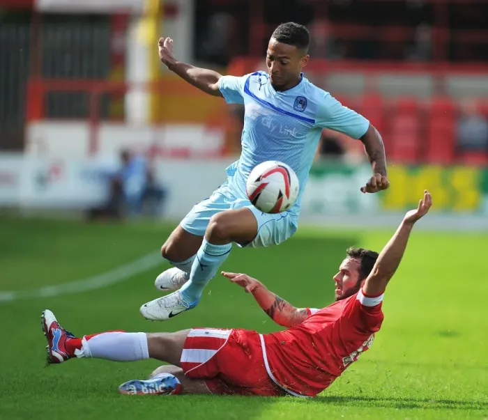 Framed Print : Jordan Clarke Soars Above Lee Moleneux in Coventry City's Pre-Season Clash at Crown Ground Framed Print : Jordan Clarke Soars Above Lee Moleneux in Coventry City's Pre-Season Clash at Crown Ground