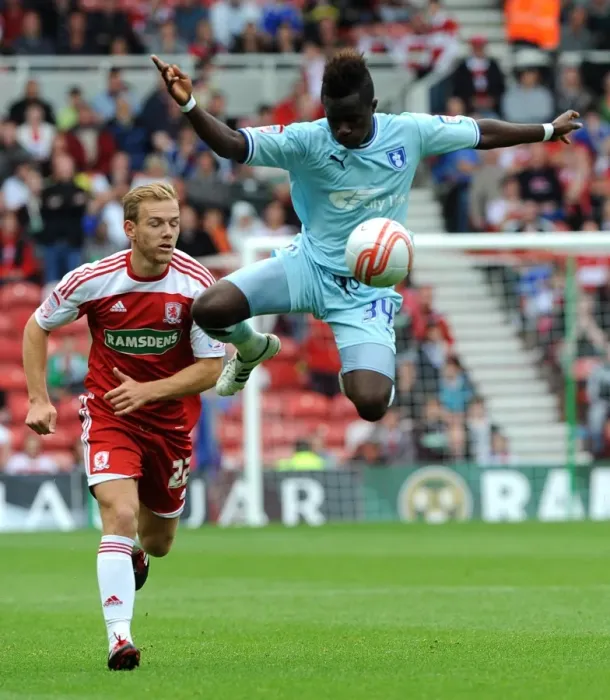 Framed Print : Soaring High: Gael Bigirimana's Aerial Mastery in Coventry City's Championship Battle at Middlesbrough (2011)