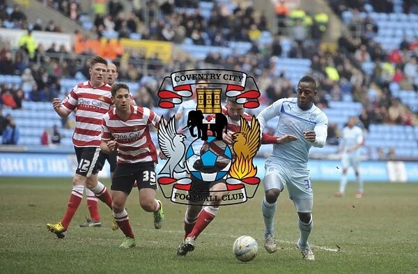 A Tense Clash: Coventry City's Franck Moussa vs Doncaster Rovers Andy Griffin in Npower League One at Ricoh Arena