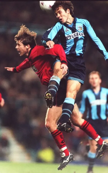 Framed Print : Thrilling Leap: Kenny Cunningham Soars Over Eion Jess in Coventry City vs Wimbledon Clash (Carling Premier League) Framed Print : Thrilling Leap: Kenny Cunningham Soars Over Eion Jess in Coventry City vs Wimbledon Clash (Carling Premier League)