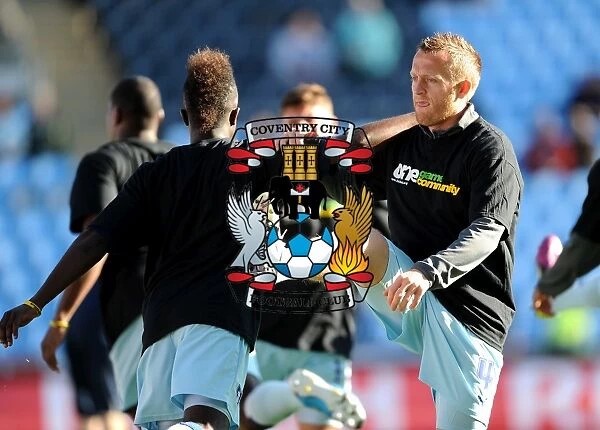 Warming Up: Gael Bigirimana and Sammy Clingan Prepare for Coventry City's Npower Championship Showdown Against Burnley (October 22, 2011, Ricoh Arena)