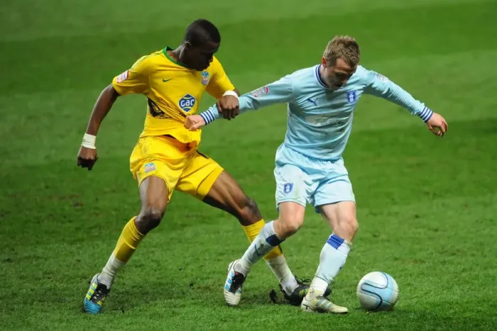 Framed Print : Wilfried Zaha vs. Gary McSheffrey: Npower Championship Showdown - A Clash at Ricoh Arena (06-03-2012)