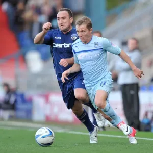 Battle for the Ball: Lee Croft vs. Gary McSheffrey - Npower League One Clash at Oldham Athletic's Boundary Park Battle for the Ball: Lee Croft vs. Gary McSheffrey - Npower League One Clash at Oldham Athletic's Boundary Park