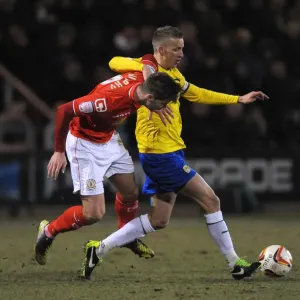 Battle for the Ball: Murphy vs. Baker in the Johnstones Paint Trophy Northern Final Battle for the Ball: Murphy vs. Baker in the Johnstones Paint Trophy Northern Final