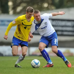 Battling for Control: Carl Baker vs. Joe Skarz in Npower League One Clash at Gigg Lane Battling for Control: Carl Baker vs. Joe Skarz in Npower League One Clash at Gigg Lane