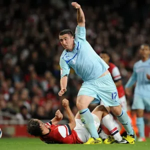 Callum Ball Dodges Ignasi Miquel in Coventry City's Capital One Cup Showdown at Arsenal's Emirates Stadium