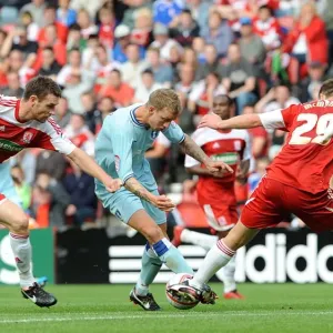Carl Baker of Coventry City Clashes with Middlesbrough's McManus and McMahon in Championship Match Carl Baker of Coventry City Clashes with Middlesbrough's McManus and McMahon in Championship Match