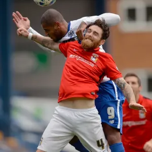 Clash at Gigg Lane: A Battle Between Leon Clarke and Romain Vincelot in Sky Bet League One Clash at Gigg Lane: A Battle Between Leon Clarke and Romain Vincelot in Sky Bet League One