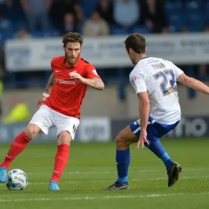 Clash on the Pitch: A Sky Bet League One Battle between Romain Vincelot and Danny Pugh at Gigg Lane Clash on the Pitch: A Sky Bet League One Battle between Romain Vincelot and Danny Pugh at Gigg Lane