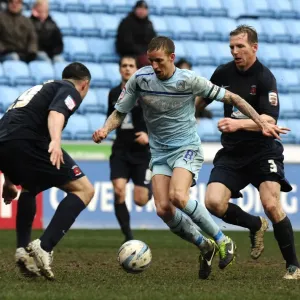 Clash at Ricoh Arena: Coventry City's Carl Baker Sandwiched Between Hartlepool's Defenders Clash at Ricoh Arena: Coventry City's Carl Baker Sandwiched Between Hartlepool's Defenders