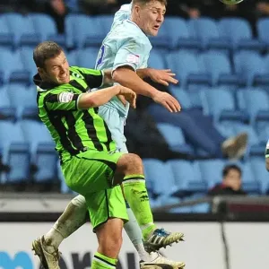 Clash at Ricoh Arena: Footballers Leap for the Ball - Coventry City vs. Brighton & Hove Albion Clash at Ricoh Arena: Footballers Leap for the Ball - Coventry City vs. Brighton & Hove Albion