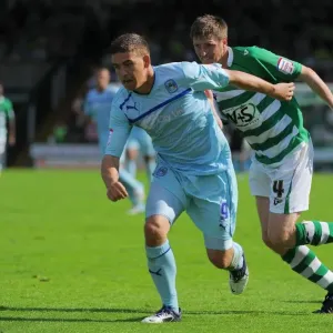 Cody McDonald's Determined Goal: Overcoming Richard Hinds in Coventry City's Victory at Huish Park (August 18, 2012) Cody McDonald's Determined Goal: Overcoming Richard Hinds in Coventry City's Victory at Huish Park (August 18, 2012)
