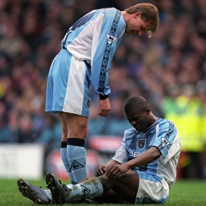 Comfort and Care: Roland Nilsson Consoles Injured George Boateng on the Field (FA Carling Premiership: Aston Villa vs Coventry City, 1999)