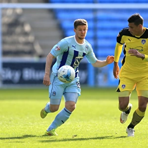Coventry Citys Aarom Phillips (left) and Colchester Uniteds Matthew Briggs battle for the ball