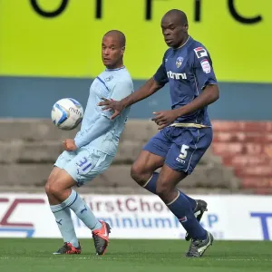 David McGoldrick vs. Jean Yves Mvoto Owono: A Fierce Battle for Possession in Coventry City's Npower League One Clash against Oldham Athletic (September 2012) David McGoldrick vs. Jean Yves Mvoto Owono: A Fierce Battle for Possession in Coventry City's Npower League One Clash against Oldham Athletic (September 2012)