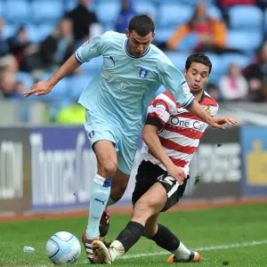 Intense Battle: Conor Thomas vs Fabien Robert in Coventry City vs Doncaster Rovers Championship Clash (April 2012) Intense Battle: Conor Thomas vs Fabien Robert in Coventry City vs Doncaster Rovers Championship Clash (April 2012)