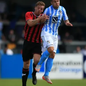 Intense Header Battle: Armstrong vs Mullins in Coventry City's Pre-Season Clash with Oxford United Intense Header Battle: Armstrong vs Mullins in Coventry City's Pre-Season Clash with Oxford United