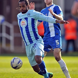 Intense Rivalry: A Clash Between Jack Baldwin and Nathan Delfouneso in the Sky Bet League One Match between Peterborough United and Coventry City