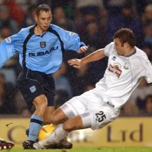 Intense Rivalry: Evatt vs. Partridge Tackle in Derby County vs. Coventry City (Nationwide League Division One, 2002) Intense Rivalry: Evatt vs. Partridge Tackle in Derby County vs. Coventry City (Nationwide League Division One, 2002)