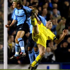 Intense Rivalry: Peed vs Kavanagh's Battle for Ball in Coventry City's FA Cup Clash against Cardiff City (January 15, 2003) Intense Rivalry: Peed vs Kavanagh's Battle for Ball in Coventry City's FA Cup Clash against Cardiff City (January 15, 2003)
