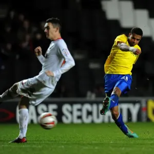 Milton Keynes Dons Shaun Williams Dodges Cyrus Christie's Shot in Npower League One Clash (December 29, 2012) Milton Keynes Dons Shaun Williams Dodges Cyrus Christie's Shot in Npower League One Clash (December 29, 2012)