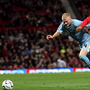 Robbie Simpson vs. Oliveira Anderson: Intense Battle for the Ball in Coventry City's Carling Cup Match against Manchester United (September 2007)