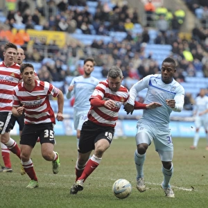 A Tense Clash: Coventry City's Franck Moussa vs Doncaster Rovers Andy Griffin in Npower League One at Ricoh Arena