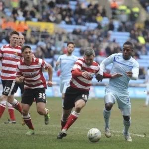 A Tense Clash: Coventry City's Franck Moussa vs Doncaster Rovers Andy Griffin in Npower League One at Ricoh Arena A Tense Clash: Coventry City's Franck Moussa vs Doncaster Rovers Andy Griffin in Npower League One at Ricoh Arena