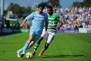 Images Dated 18th August 2012: Adam Barton Outsmarts Reuben Reid: Coventry City vs. Yeovil Town in Npower League One Clash at