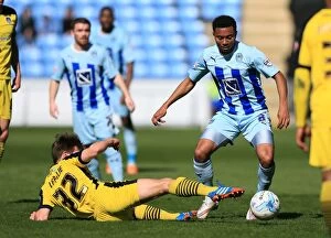 Images Dated 11th April 2015: Battle for the Ball: Grant Ward vs Tom Lapslie - Coventry City vs Colchester United