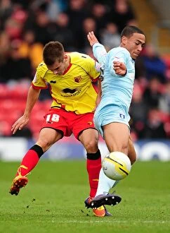 17-03-2012 v Watford, Vicarage Road Collection: Battle for the Ball: Kacaniklic vs. Clarke in Coventry City's Npower Championship Clash at
