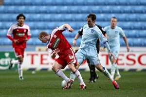 Images Dated 21st January 2012: Battle for the Ball: Keogh vs. Robson - Coventry City vs. Middlesbrough Championship Clash