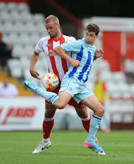 Prints of Stevenages Harry Worley (left) and Coventry Citys Shaun Miller (right) battle for the ball Pre-season Friendly Prints: Battle for the Ball
