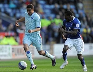 Images Dated 3rd March 2012: Battle at The King Power Stadium: Lloyd Dyer vs Cyrus Christie - Npower Championship Clash