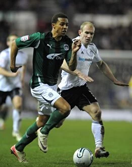 Images Dated 14th January 2012: Battling for the Ball: Cyrus Christie vs. Gareth Roberts - Derby County vs