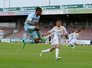 Images Dated 8th September 2013: Callum Wilson Sends a Soaring Cross at Sixfields Stadium during Coventry City vs Colchester United
