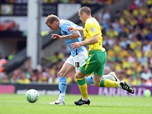 07-05-2011 v Norwich City, Carrow Road Collection: Carl Baker vs. Andrew Crofts: Intense Battle for Ball Possession in Coventry City vs