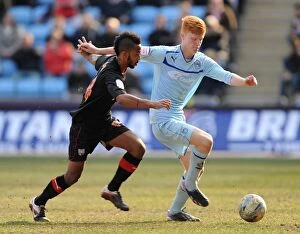 Images Dated 6th April 2013: Challenge at Ricoh Arena: Coventry City's Shaleum Logan vs. Brentford's Ryan Haynes