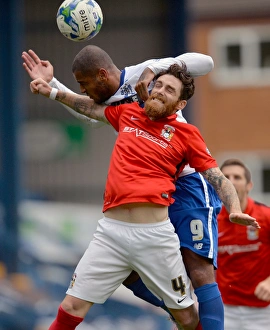Clash at Gigg Lane: A Battle Between Leon Clarke and Romain Vincelot in Sky Bet League One