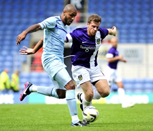 Images Dated 2013 July: Clash at Kassam: Leon Clarke vs John Mullins - A Battle for Supremacy
