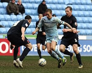 Images Dated 16th March 2013: Clash at Ricoh Arena: Coventry City's Carl Baker Sandwiched Between Hartlepool's Defenders