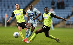 Images Dated 2015 April: Clash at Ricoh Arena: Sanmi Odelusi vs Genserix Kusunga - Sky Bet League One Showdown