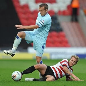 29-10-2011 v Doncaster Rovers, Keepmoat Stadium Collection: Clingan vs. Coppinger: Intense Tackle in Coventry City vs. Doncaster Rovers Championship Clash