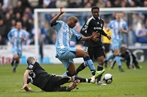 07-03-2009 Round 6 v Chelsea Collection: Clinton Morrison Leaps Over Chelsea's Alex in FA Cup Sixth Round Showdown at Ricoh Arena