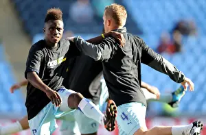 Images Dated 22nd October 2011: Coventry City FC: One Community - Gael Bigirimana and Sammy Clingan Warm Up in Unity T-shirts (vs Burnley)