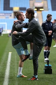 Images Dated 21st January 2012: Coventry City FC: Sammy Clingan and Hermann Hreidarsson Stretching During Warm-Up at Ricoh Arena
