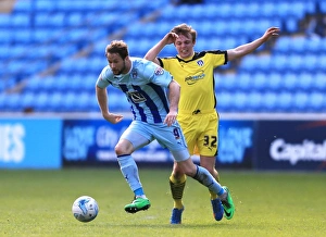 Coventry City sNick Proschwitz (left) and Colchester Uniteds Tom Lapslie battle for the ball