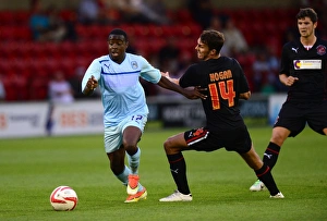 Images Dated 2013 July: Coventry City vs Fleetwood Town: A Pre-Season Battle - Eli Bako vs Liam Hogan (July 24)